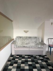 a room with a couch and a checkered floor at panoramic sondrio in Sondrio