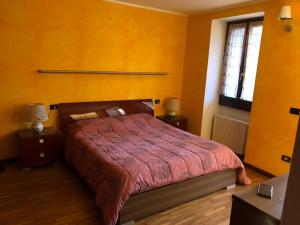 a bedroom with a bed and two night stands and a window at panoramic sondrio in Sondrio