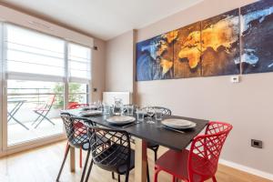 a dining room with a table with chairs and a map on the wall at La Dolce Vita By Plaza in Chessy