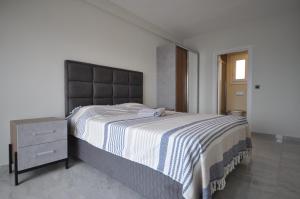 a bedroom with a large bed and a dresser at Castamar Residence in Bodrum City +15 photos