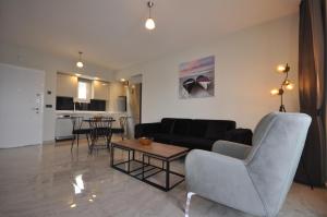 a living room with a couch and a table at Castamar Residence in Bodrum City