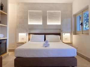A bed or beds in a room at Gattarella Family Resort Puglia- Seaside Rooms and Suites with Premium Half-Board à la carte