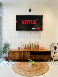 a television on a wall with a netflix sign on it at AnandMai - Sustainable Living Spaces in Jaipur