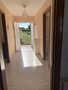 a hallway with a door and a view of a yard at Apartamento en Rias Baixas-Aguiño-Ribeira in Ribeira