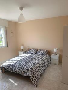 a bedroom with a bed and two night stands at Apartamento en Rias Baixas-Aguiño-Ribeira in Ribeira +7 photos