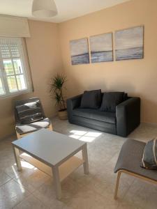 a living room with a couch and a table at Apartamento en Rias Baixas-Aguiño-Ribeira in Ribeira