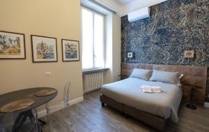 A bed or beds in a room at Household Settembrini