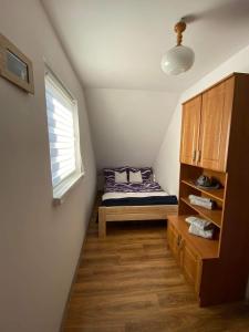 a small bedroom with a bed and a window at Willa Paulina in Nadole