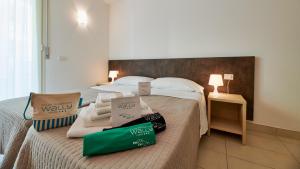 a hotel room with a bed with bags on it at Wally Residence in Rimini