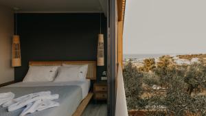 a bedroom with a bed and a view of the desert at Zante Calinica Hotel in Tsilivi +113 photos