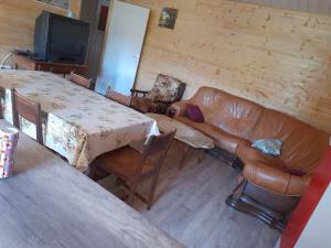 a living room with a couch and a table at Maisons du Père Paille in Usclades