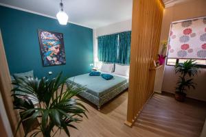 a bedroom with a bed and a plant in it at Efie's Studio in Kalamata