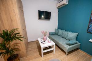 a living room with a couch and a table at Efie's Studio in Kalamata