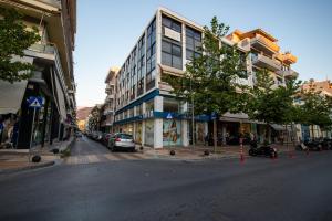 a city street with cars parked on the side of a building at Efie's Studio in Kalamata