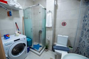 a bathroom with a shower and a washing machine at Efie's Studio in Kalamata +30 photos