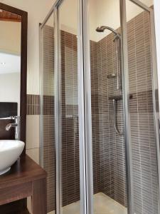 a bathroom with a shower and a sink at Bonnie Banks Lodge Ardlui in Ardlui