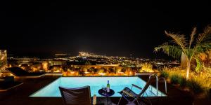 a view of a swimming pool at night at Apikia Santorini in Pyrgos