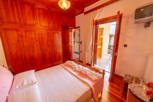 a bedroom with a bed and a large window at Traditional village house in Ágios Matthaíos