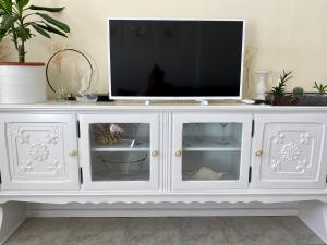 a white cabinet with a television on top of it at Niky in Betina