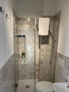 a bathroom with a shower and a toilet and a sink at Dimora La Terrazza in Polignano a Mare