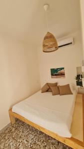 a bedroom with a bed with a white bedspread at Dimora La Terrazza in Polignano a Mare