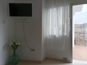 Televízia a/alebo spoločenská miestnosť v ubytovaní Apartamento O Vento