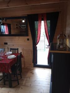 a dining room with a table and a large window at Domek na grapie in Gilowice
