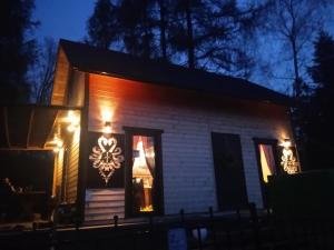 uma casa com luzes de lado à noite em Domek na grapie em Gilowice