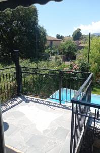 a balcony with a fence and a swimming pool at La Rosa dell'Etna in Castiglione di Sicilia