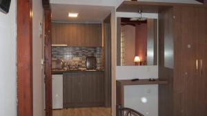 a kitchen with wooden cabinets and a counter top at House Roula in Neos Marmaras