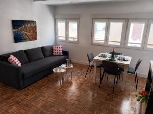 a living room with a couch and a table at NEW MARITIMO in Málaga