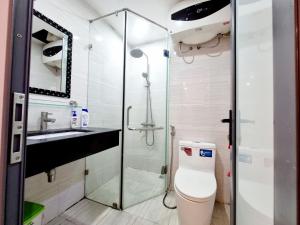 a bathroom with a shower and a toilet and a sink at LaHomestay Phủ Doãn in Hanoi +47 photos