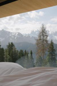 a view of a mountain range from a bedroom window at anders mountain suites 6 in Brixen