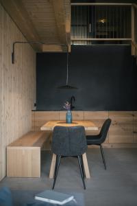 a room with a table and a chair and a blackboard at anders mountain suites 6 in Brixen