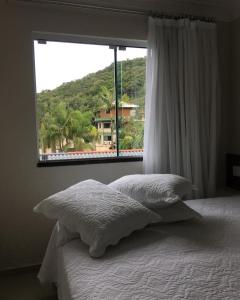 Giường trong phòng chung tại Resort e Spa Summer Beach Bombinhas apto 107