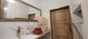 a bathroom with a sink and a mirror and a red teddy bear at Gwiazda Polarna in Olsztyn