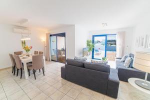 a living room with a couch and a table at Coloradas Villa Alba in Playa Blanca