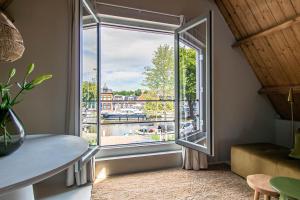 a window in a room with a view of a river at Dok 20, Lemmer in Lemmer