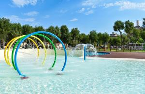 a water park with a water slide in the water at Club del Sole Rimini Family Resort in Rimini