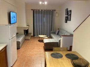 a small living room with a couch and a table at enJOY Golden beach in Skala Potamias
