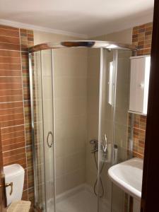 a bathroom with a shower and a toilet and a sink at enJOY Golden beach in Skala Potamias +38 photos