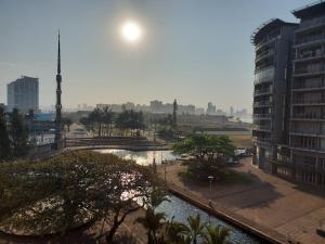 a view of a city with a river and buildings at Ocean Sunrise at the Sails - Durban point waterfront in Durban