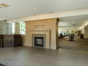 a lobby with a fireplace in a building at Donald Gordon Hotel and Conference Centre in Kingston