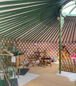 an inside of a yurt with a table and chairs at Valhalla Yurts Odin in Selfoss