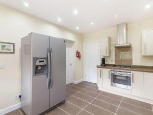 a large kitchen with a stainless steel refrigerator at Entire property next to Severn Valley Railway in Highley