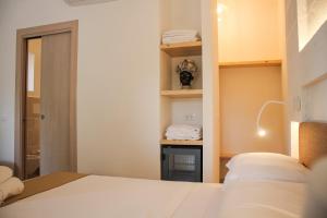 A bed or beds in a room at Gattarella Family Resort Puglia- Seaside Rooms and Suites with Premium Half-Board à la carte