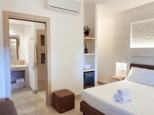 A bed or beds in a room at Gattarella Family Resort Puglia- Seaside Rooms and Suites with Premium Half-Board à la carte
