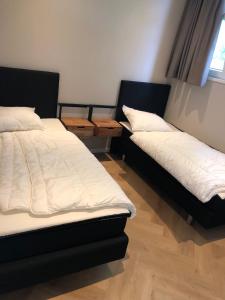 two beds are sitting in a room withskirts at Luxus Chalet Hafenblick in Lathum