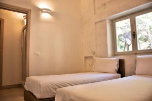A bed or beds in a room at Gattarella Family Resort Puglia- Seaside Rooms and Suites with Premium Half-Board à la carte