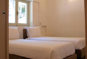 A bed or beds in a room at Gattarella Family Resort Puglia- Seaside Rooms and Suites with Premium Half-Board à la carte
